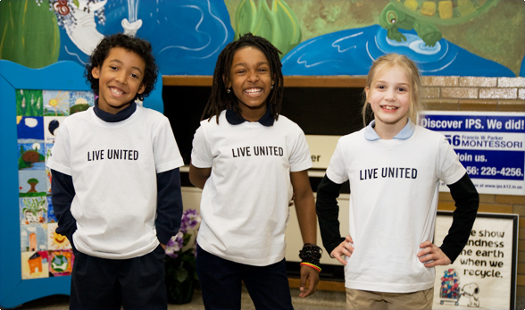 Three Children Wearing Live United T-Shirts