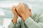 Man holding head in hands