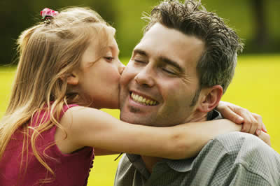 Daughter kissing father