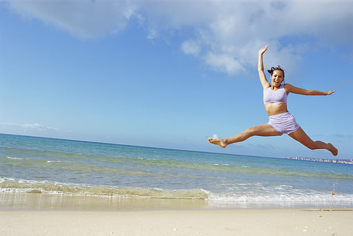 woman jumping on beach